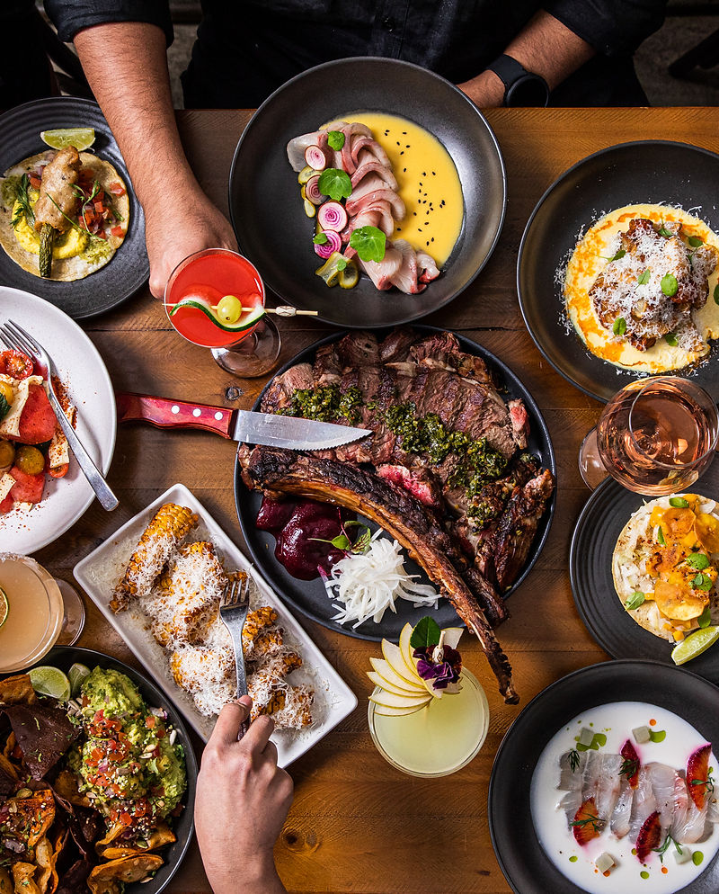 Tommy's banquet spread with multiple dishes and cocktails
